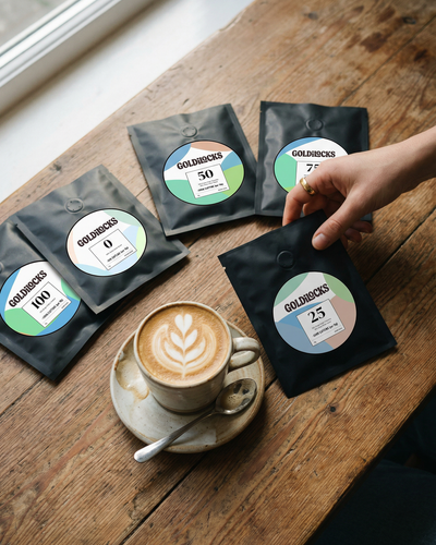 Goldilocks Coffee Calibration Kit - hand picking a bag from all five levels on a cafe table