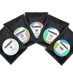 Five 25g coffee bags arranged together, one of each caffeine level: 0, 25, 50, 75, and 100